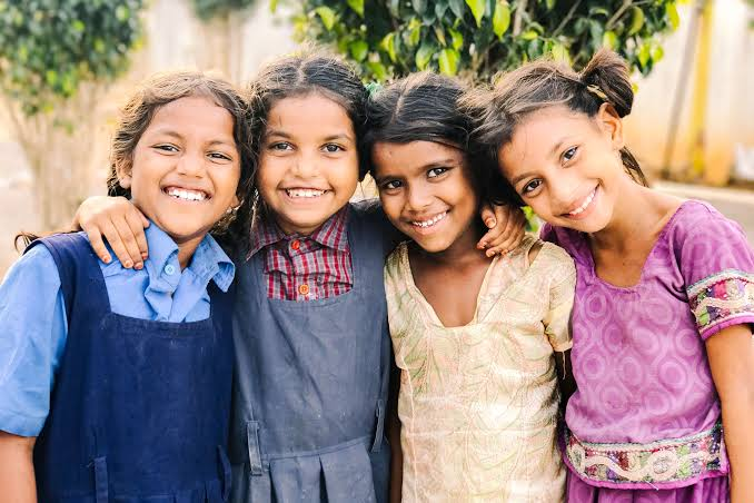 Children smiling together, representing lives and hope in the community